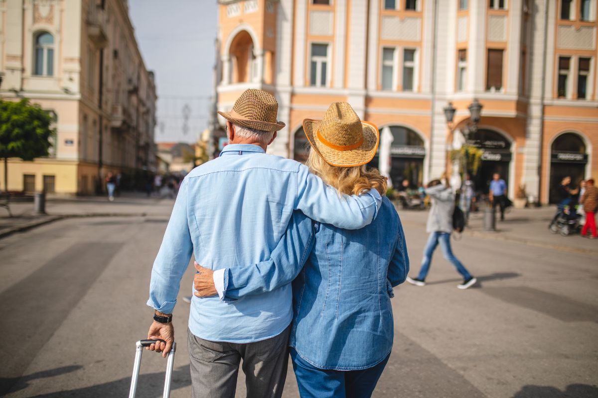 happy couple walking arm in arm through a city center